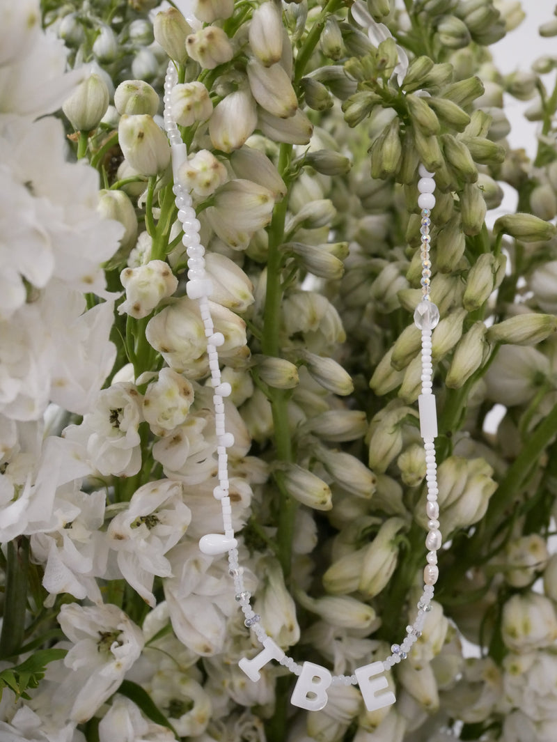 Delicate bridal necklace with mother-of-pearl initials and bead details