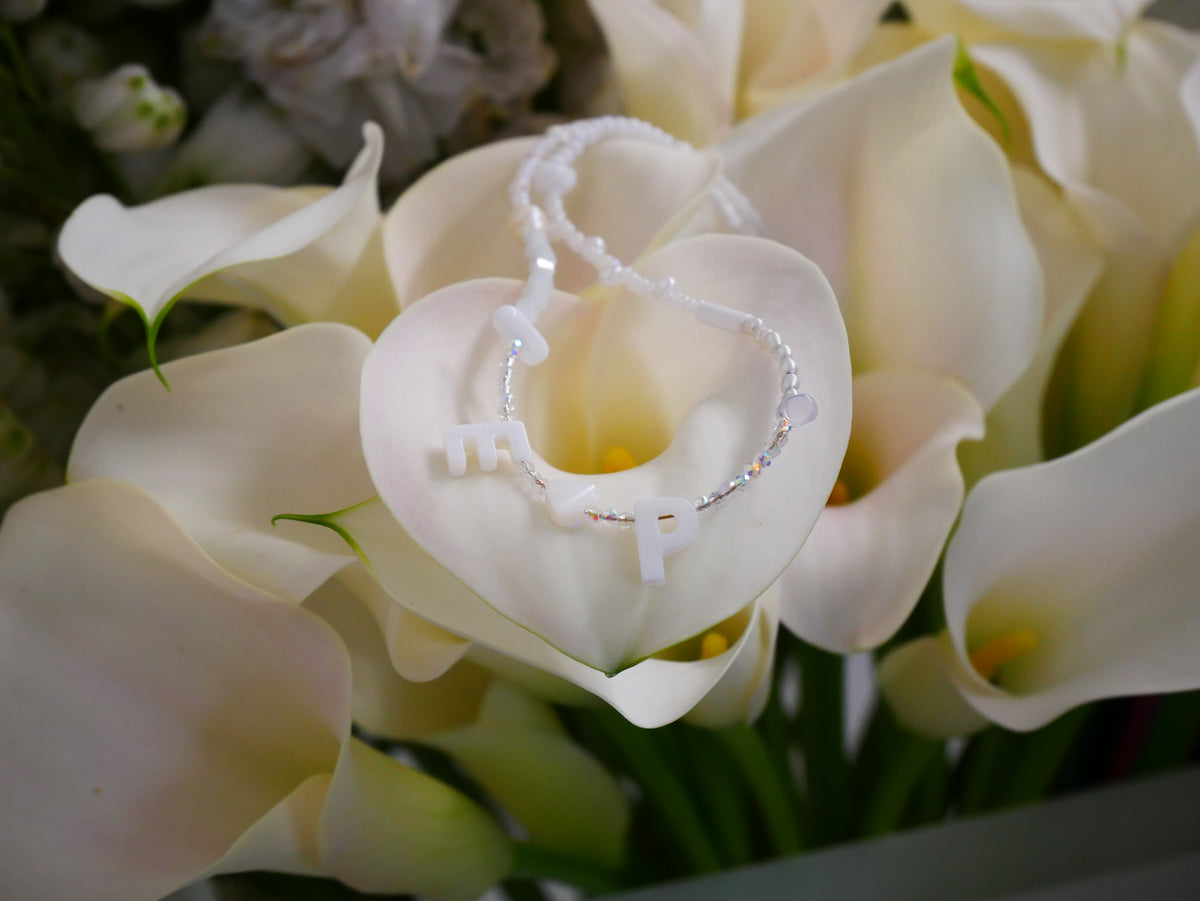 A delicate bridal necklace styled with white flowers